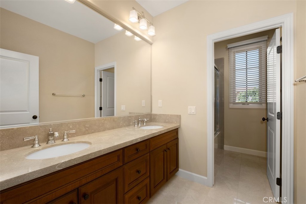 61 Triana Irvine, CA 92618 - Photo 28 of 56 a bathroom with double vanity sinks and a mirror