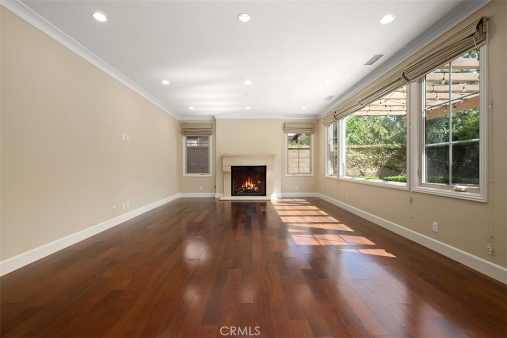 61 Triana Irvine, CA 92618 - Photo 7 of 56 an empty room with wooden floor and fireplace