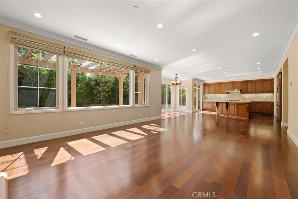 61 Triana Irvine, CA 92618 - Photo 10 of 56 a view of an empty room with wooden floor and a window
