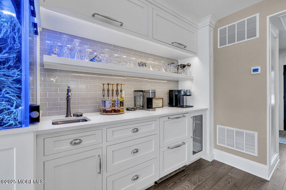 2547 River Road Manasquan, NJ 08736 - Photo 18 of 75 a kitchen with white cabinets and sink