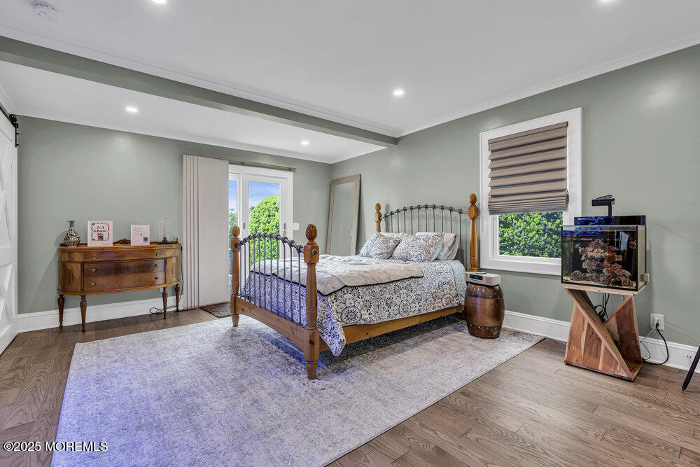 2547 River Road Manasquan, NJ 08736 - Photo 34 of 75 a bedroom with a bed and a book shelf