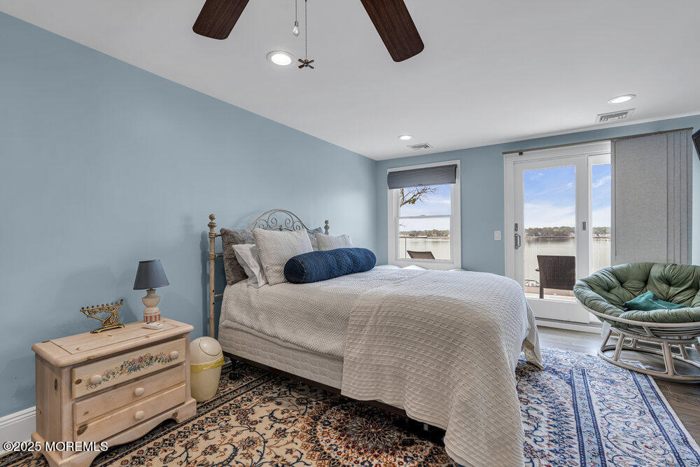 2547 River Road Manasquan, NJ 08736 - Photo 47 of 75 a bedroom with a bed and large windows