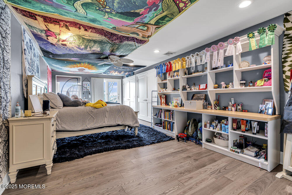 2547 River Road Manasquan, NJ 08736 - Photo 50 of 75 a bedroom with furniture and a book shelf