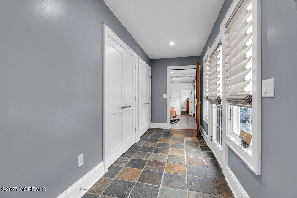 2547 River Road Manasquan, NJ 08736 - Photo 51 of 75 a view of a hallway with wooden floor and a bathroom