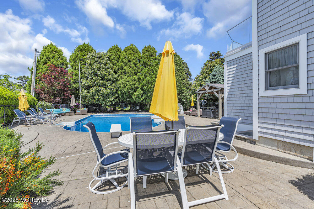 2547 River Road Manasquan, NJ 08736 - Photo 63 of 75 a view of a patio with table and chairs and potted plants