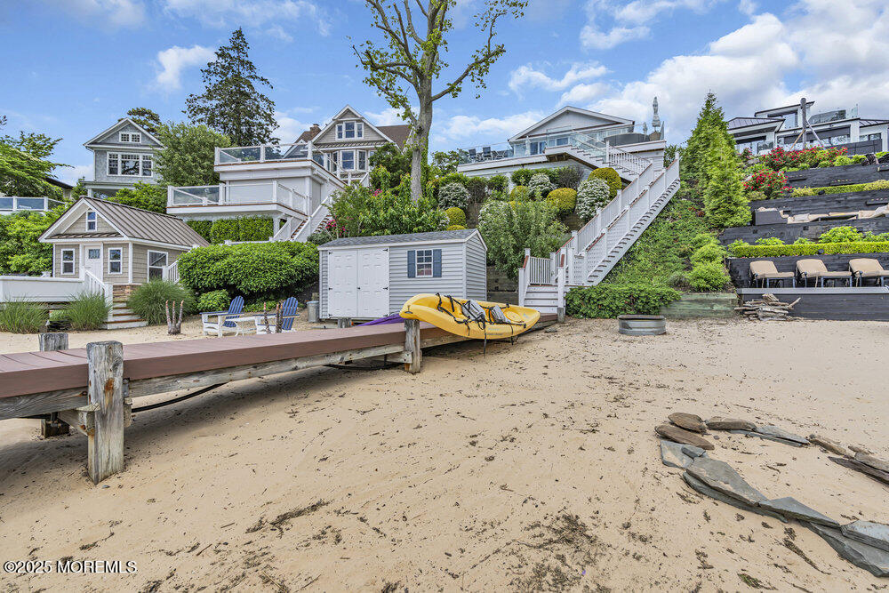 2547 River Road Manasquan, NJ 08736 - Photo 69 of 75 a backyard of a house with barbeque oven fire pit table and chairs
