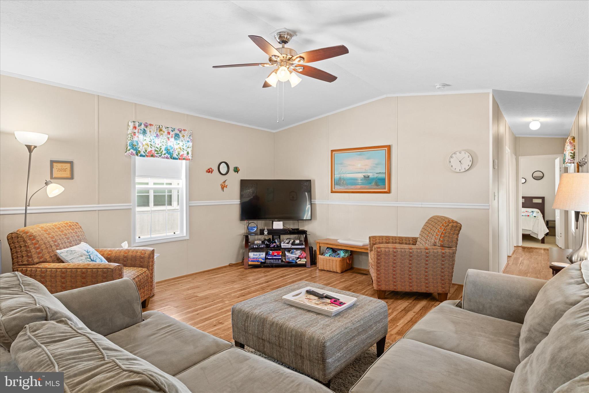 33461 Daisy Street Lewes, DE 19958 - Photo 12 of 42 a living room with furniture a flat screen tv and a window