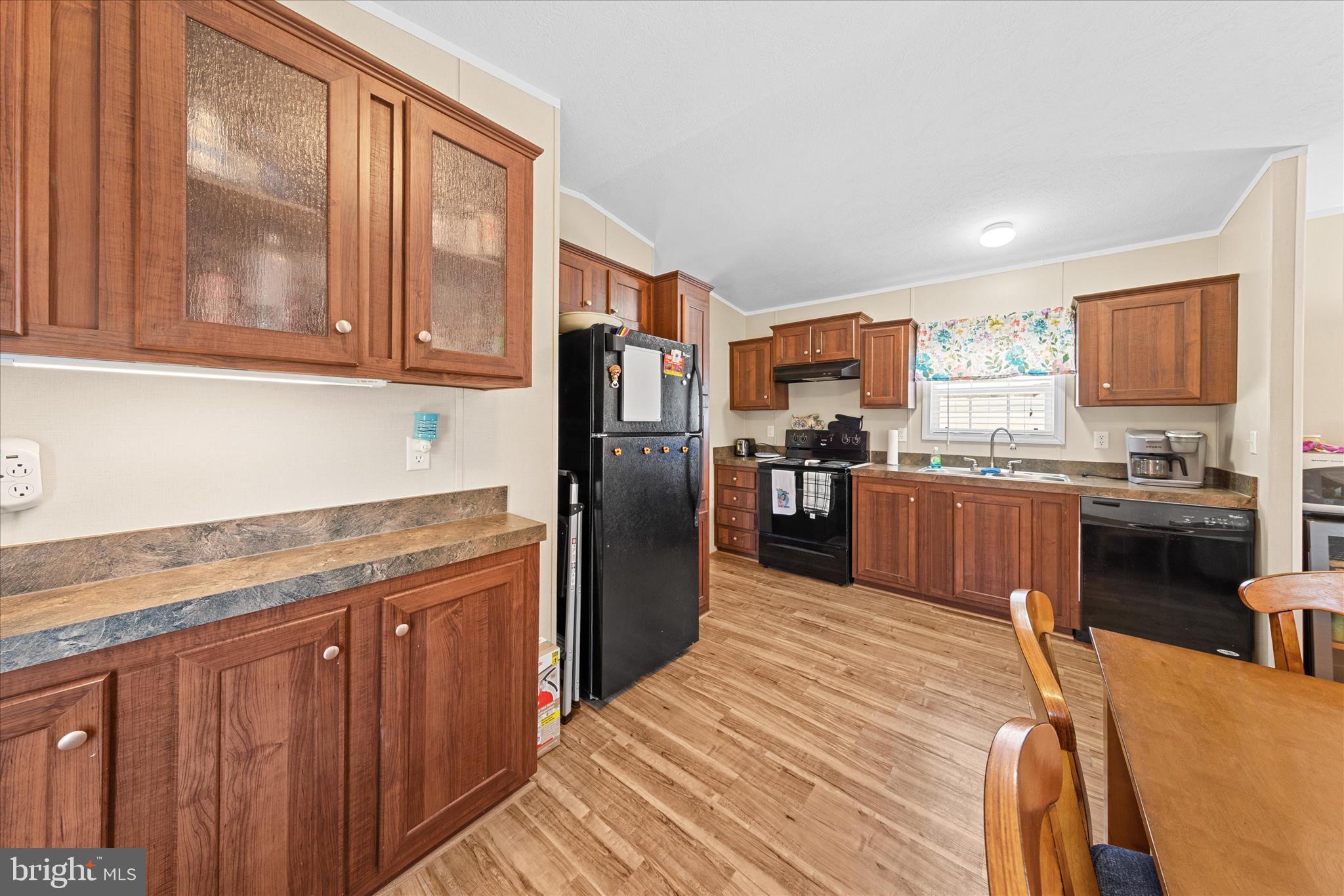 33461 Daisy Street Lewes, DE 19958 - Photo 13 of 42 a kitchen with stainless steel appliances granite countertop a refrigerator a stove top oven a sink and dishwasher