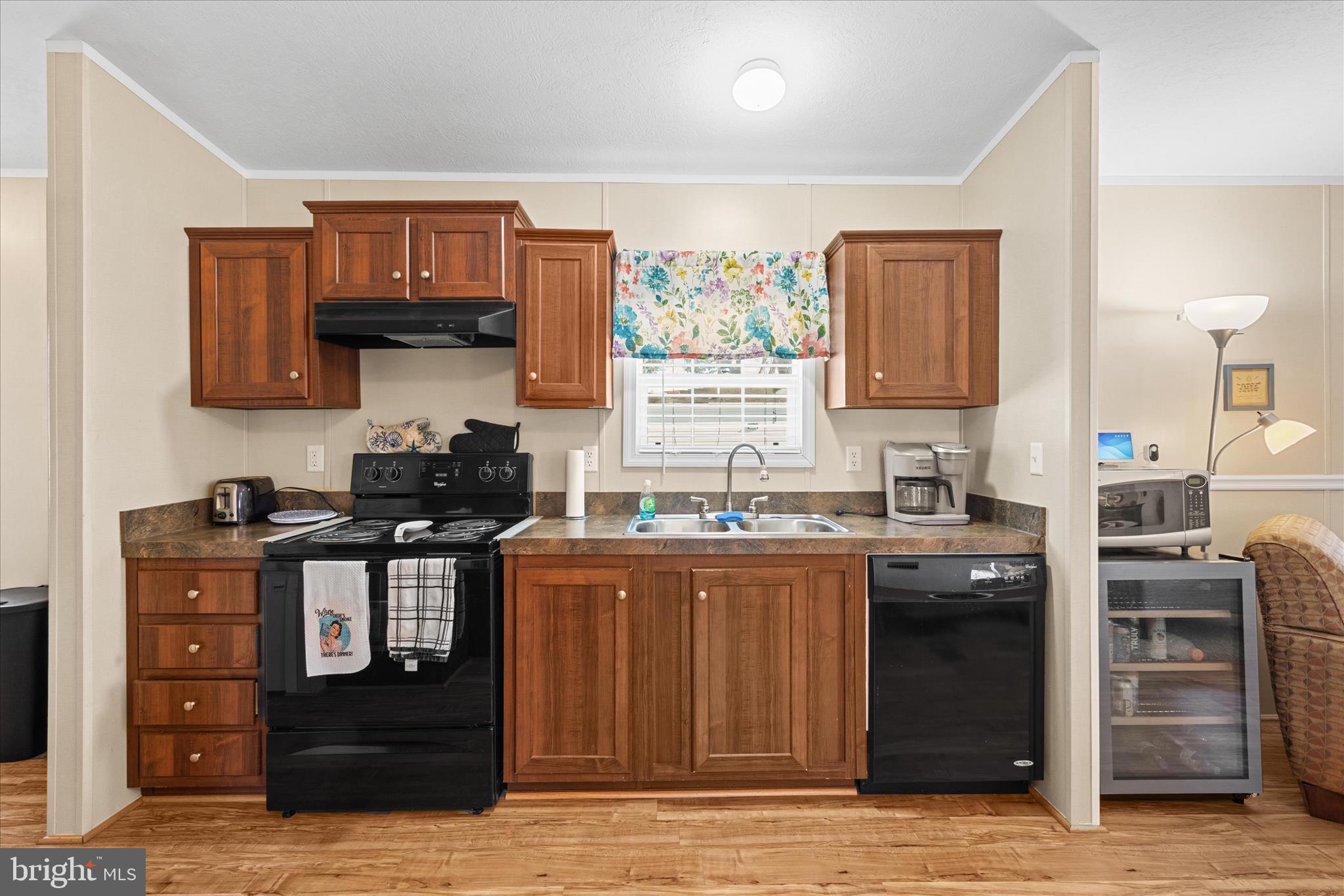33461 Daisy Street Lewes, DE 19958 - Photo 18 of 42 a kitchen with stainless steel appliances granite countertop a stove and cabinets