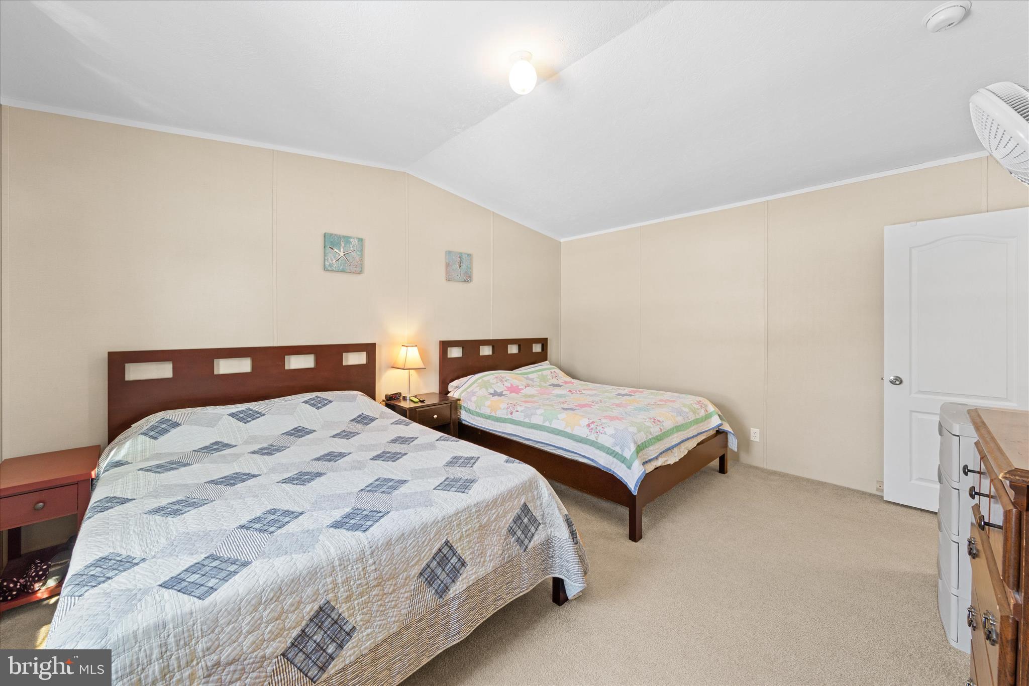 33461 Daisy Street Lewes, DE 19958 - Photo 23 of 42 a bedroom with two beds and a lamp
