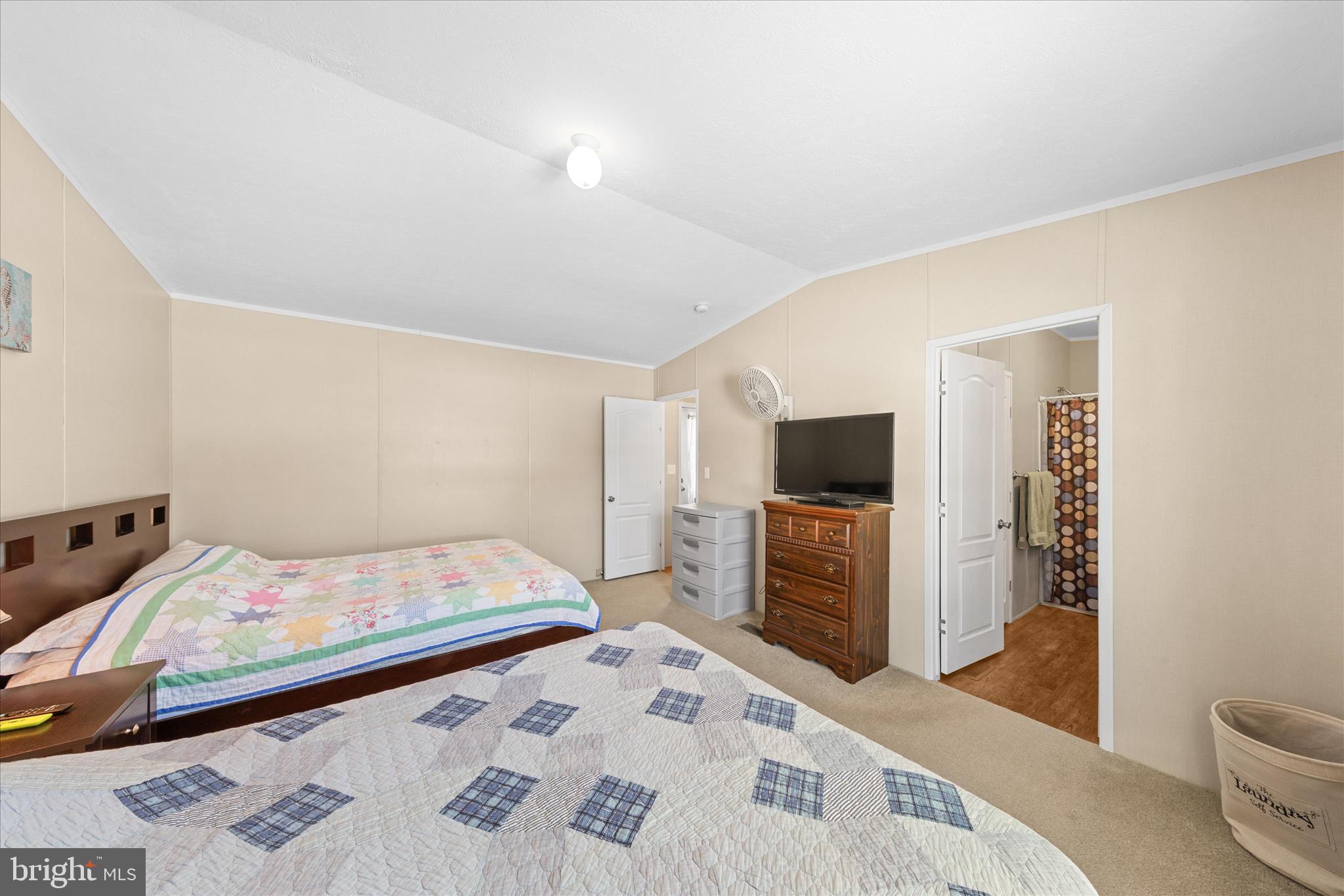 33461 Daisy Street Lewes, DE 19958 - Photo 25 of 42 a bedroom with a bed and a television in it