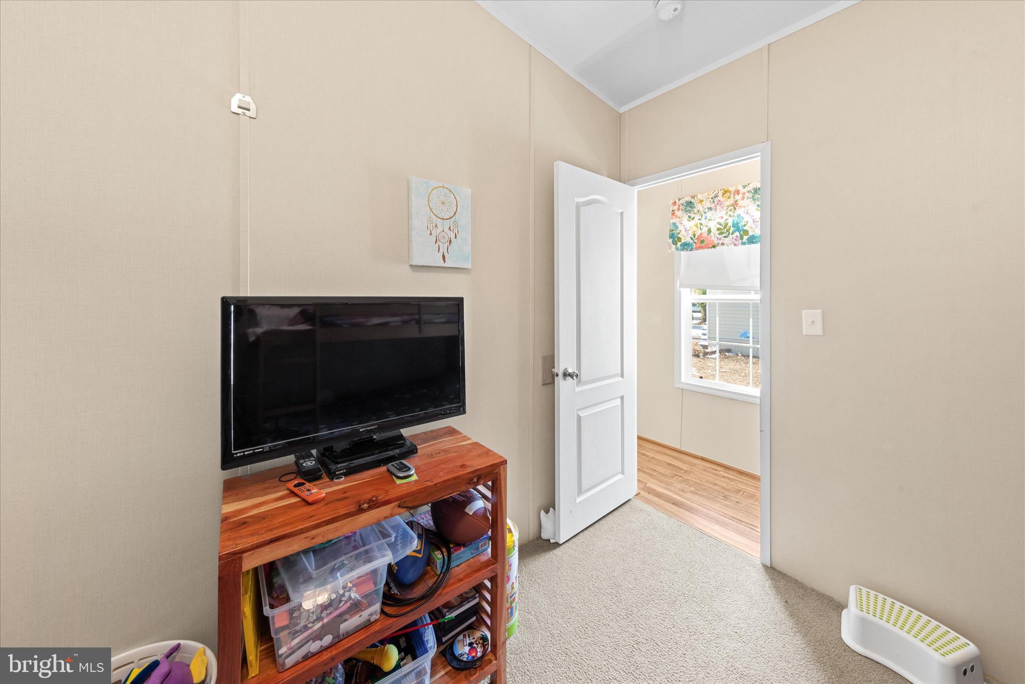 33461 Daisy Street Lewes, DE 19958 - Photo 30 of 42 a living room with furniture and a flat screen tv