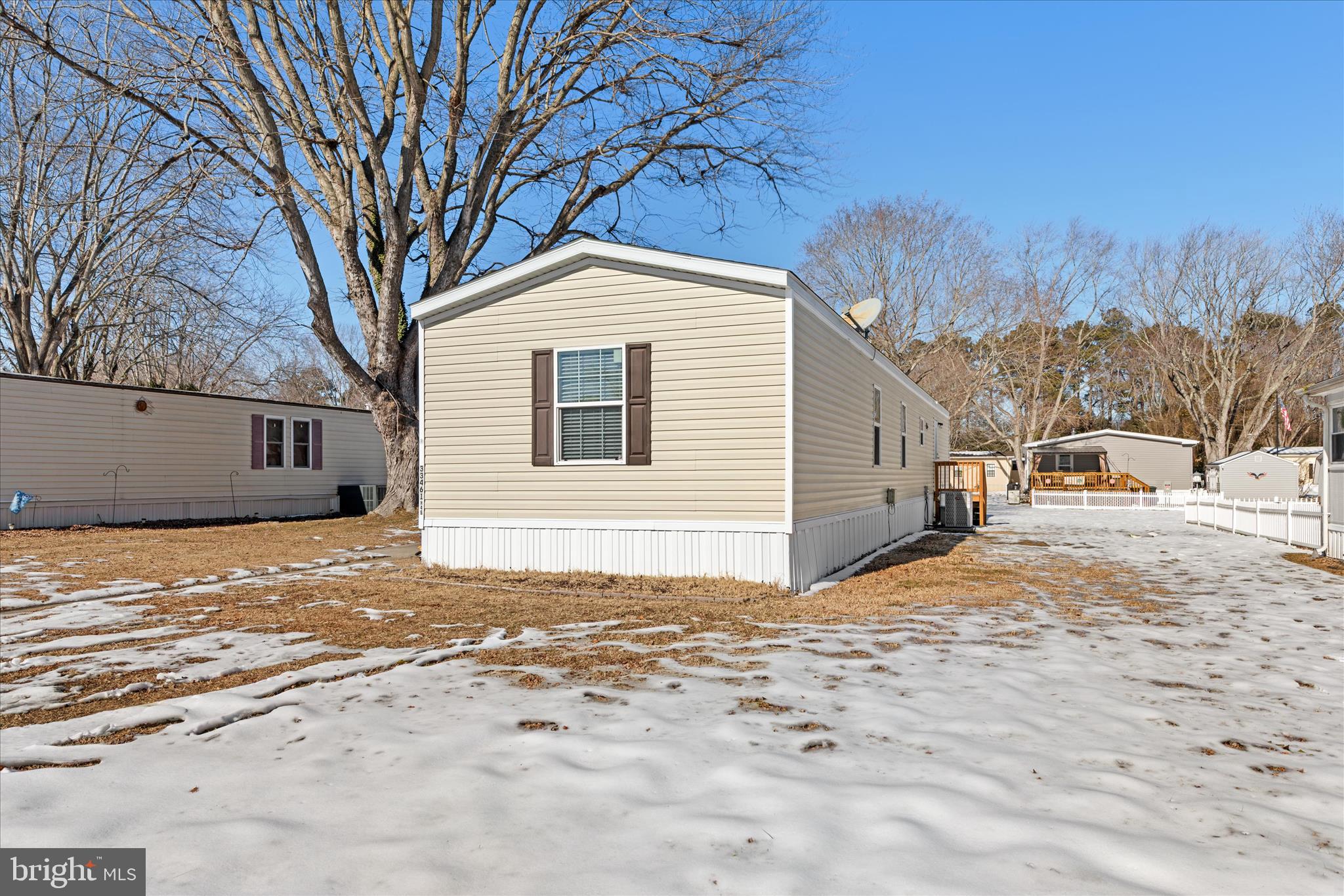 33461 Daisy Street Lewes, DE 19958 - Photo 3 of 42 a view of a white house with a yard covered in snow