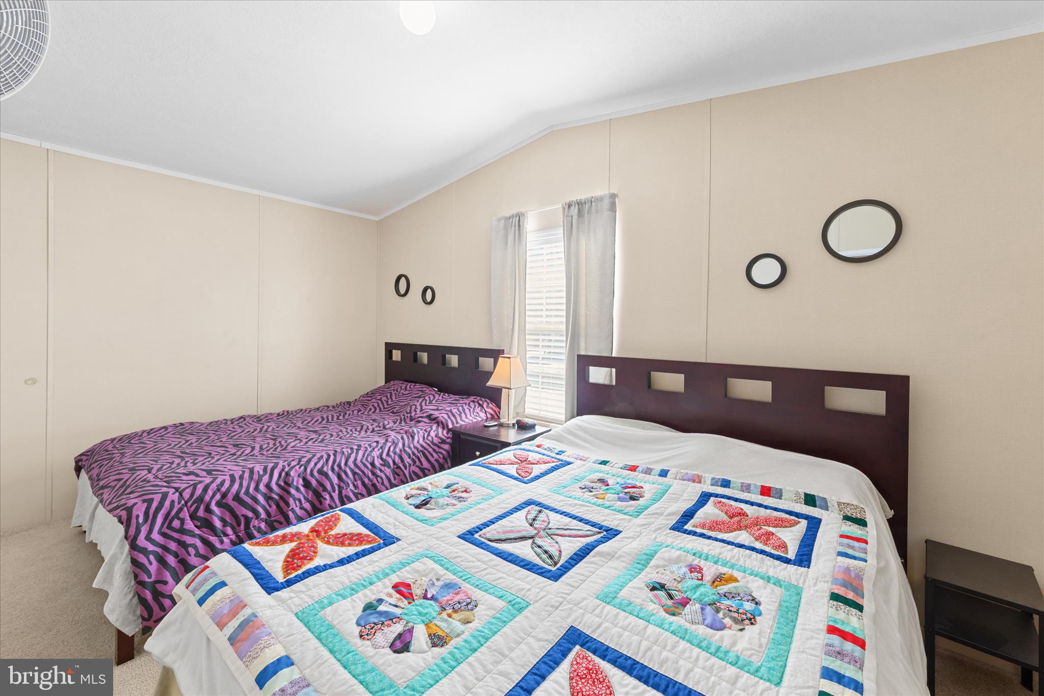 33461 Daisy Street Lewes, DE 19958 - Photo 34 of 42 a bedroom with a bed and a lamp on dresser