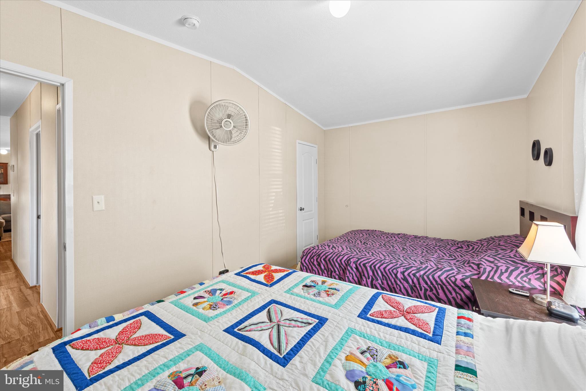 33461 Daisy Street Lewes, DE 19958 - Photo 37 of 42 a bedroom with a bed and a lamp on dresser