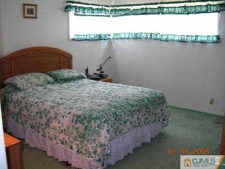 12 Bucknell Road Old Bridge, NJ 08859 - Photo 5 of 8 a bedroom with a bed and a night stand