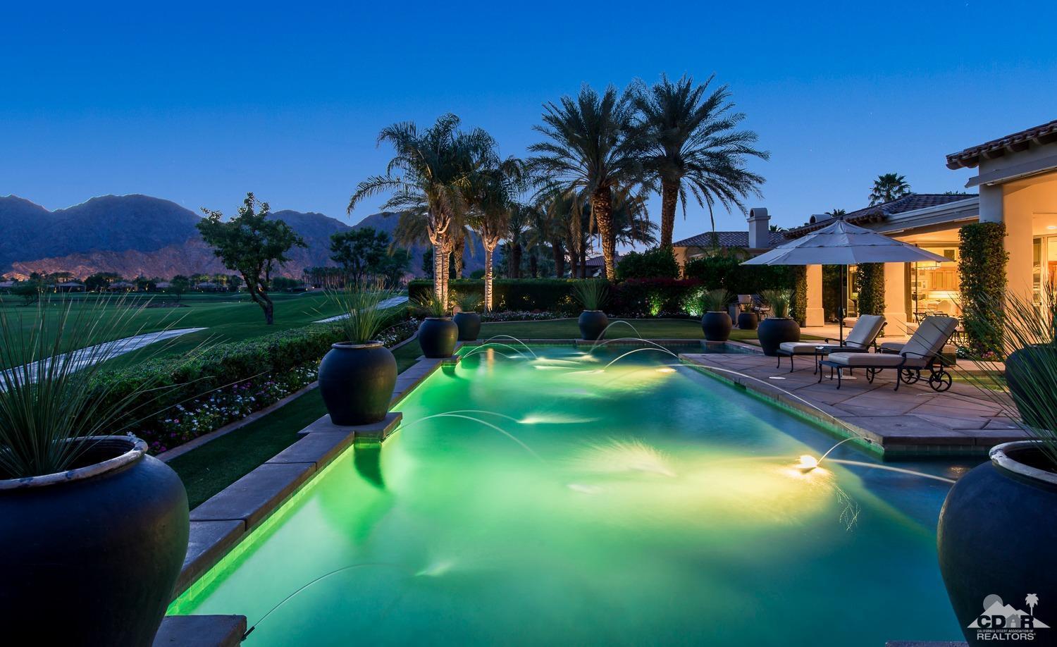 80515 Weiskopf La Quinta, CA 92253 - Photo 1 of 46 a view of a swimming pool with lawn chairs under an umbrella