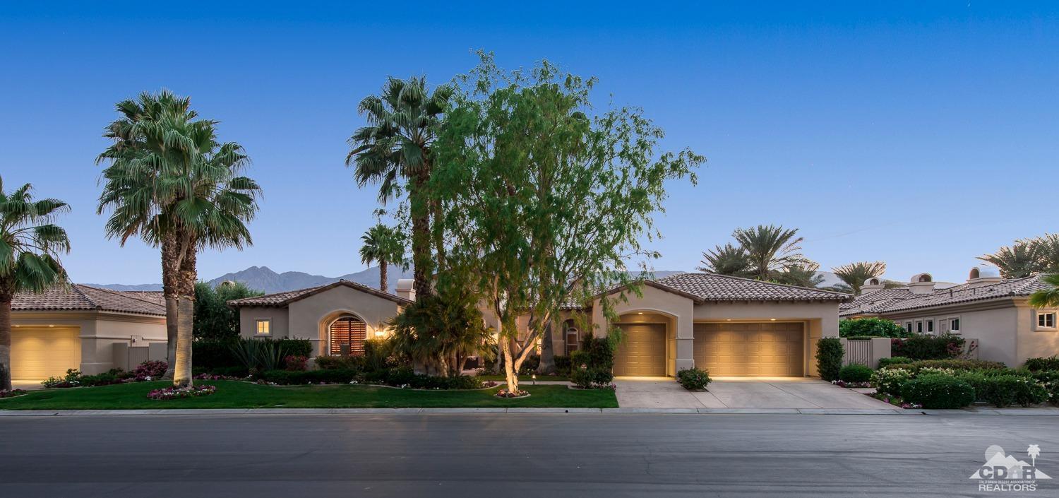 80515 Weiskopf La Quinta, CA 92253 - Photo 13 of 46 a front view of a house with a garden and a yard