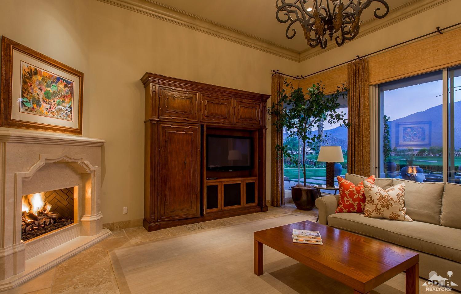 80515 Weiskopf La Quinta, CA 92253 - Photo 19 of 46 a living room with furniture a fireplace and a chandelier