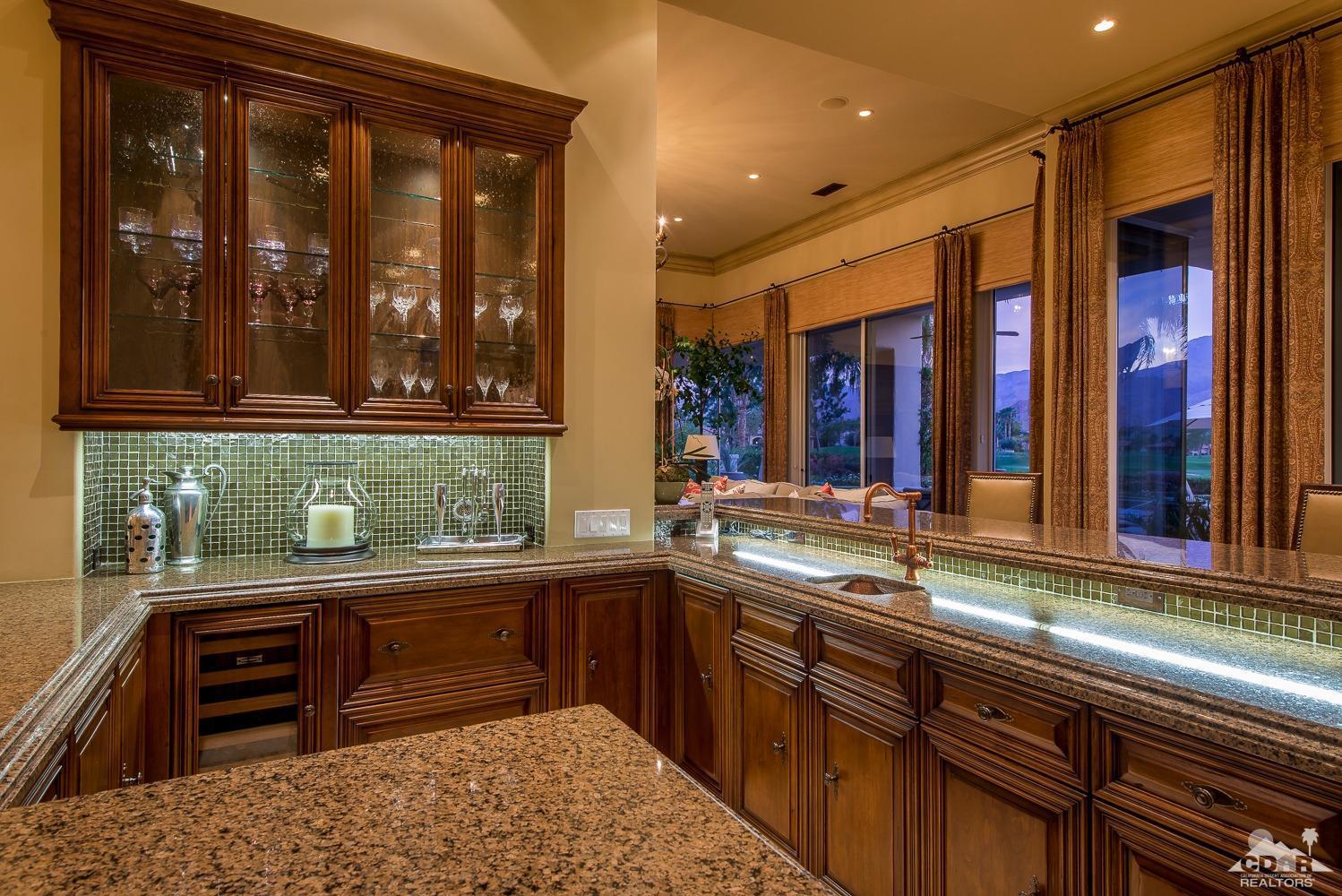 80515 Weiskopf La Quinta, CA 92253 - Photo 28 of 46 a kitchen with stainless steel appliances granite countertop a sink and cabinets