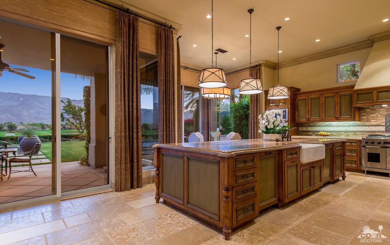 80515 Weiskopf La Quinta, CA 92253 - Photo 34 of 46 a kitchen with stainless steel appliances granite countertop a stove a sink and a refrigerator