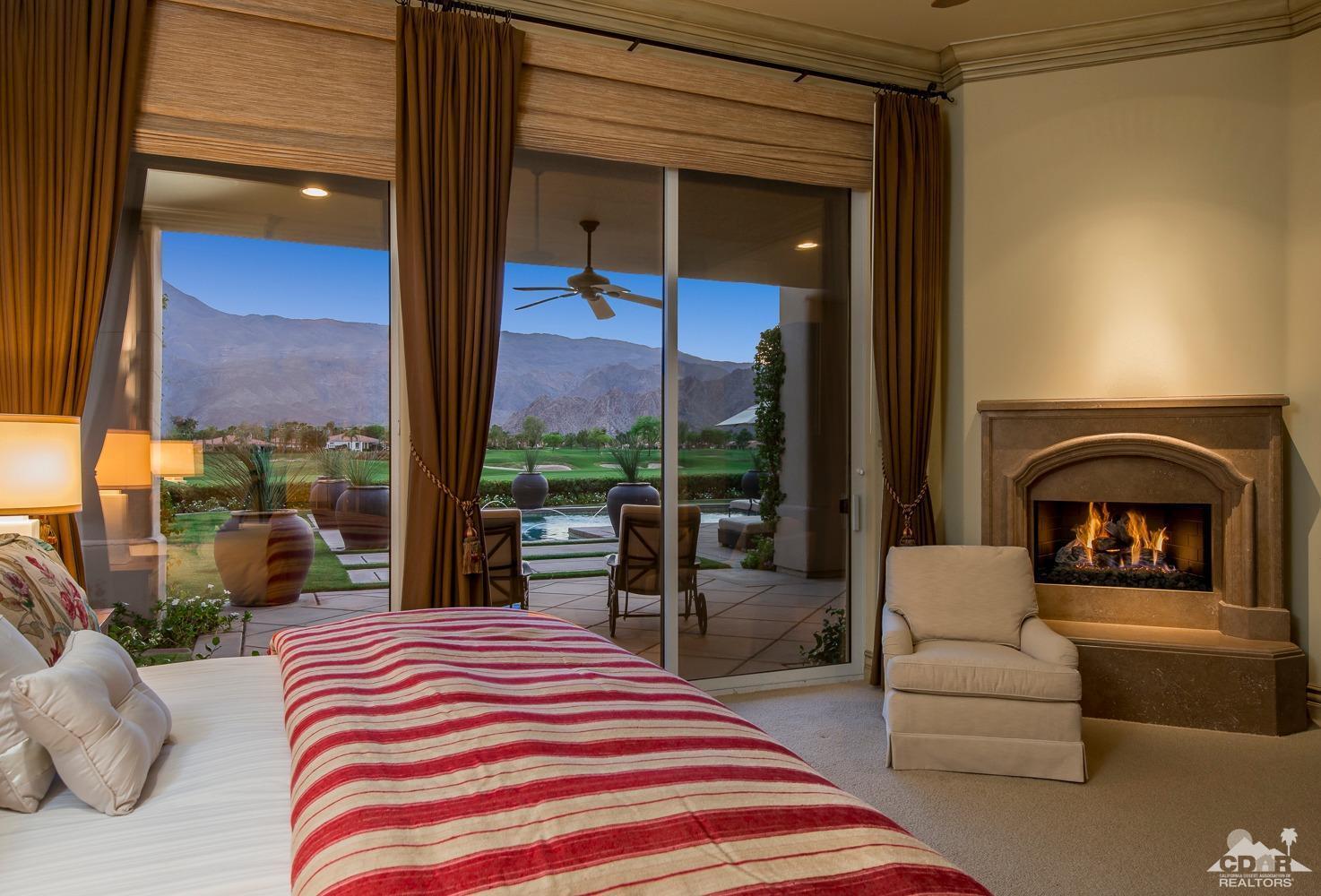 80515 Weiskopf La Quinta, CA 92253 - Photo 41 of 46 a bedroom with a bed and a large window with balcony view