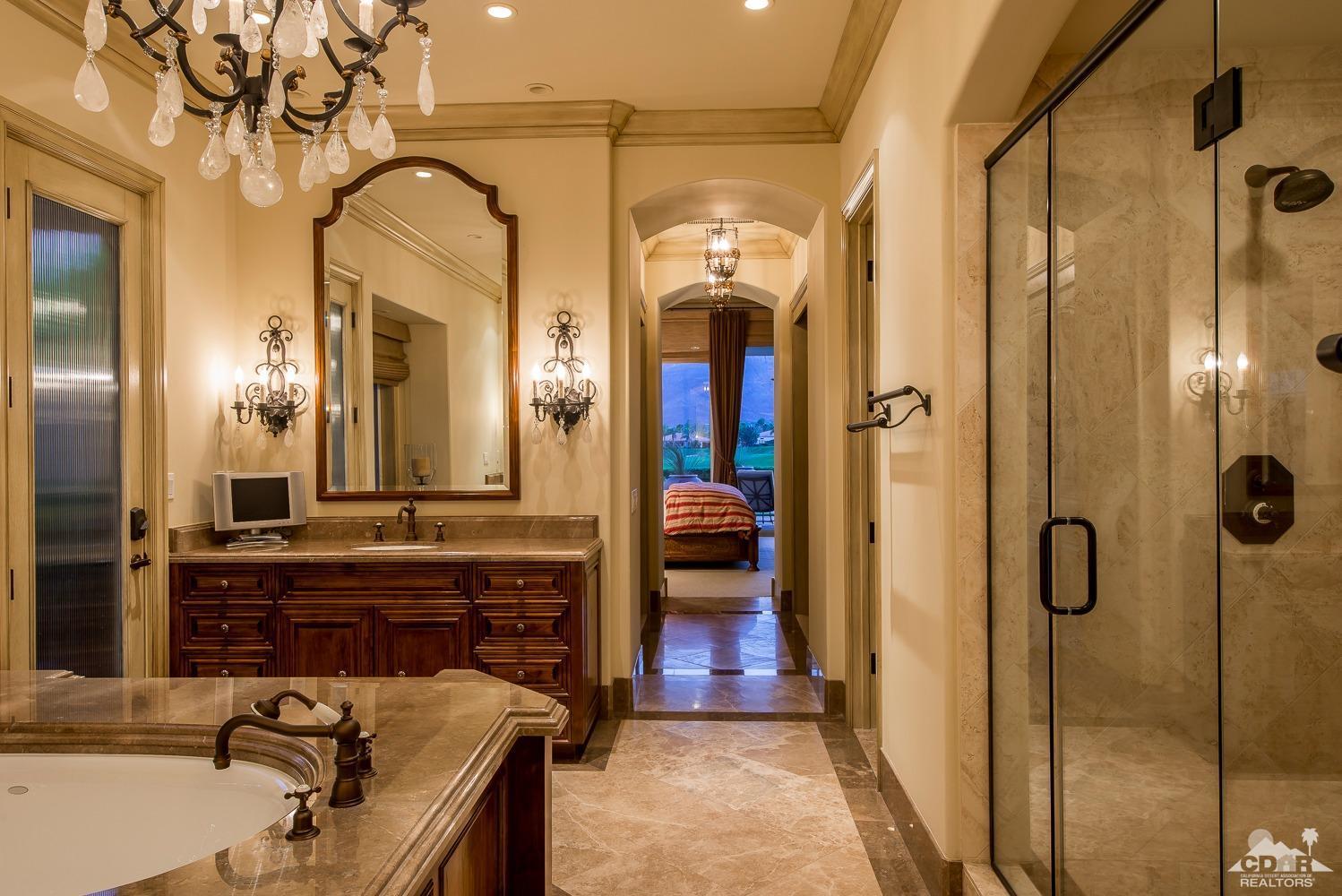 80515 Weiskopf La Quinta, CA 92253 - Photo 43 of 46 a spacious bathroom with a granite countertop sink a mirror and shower
