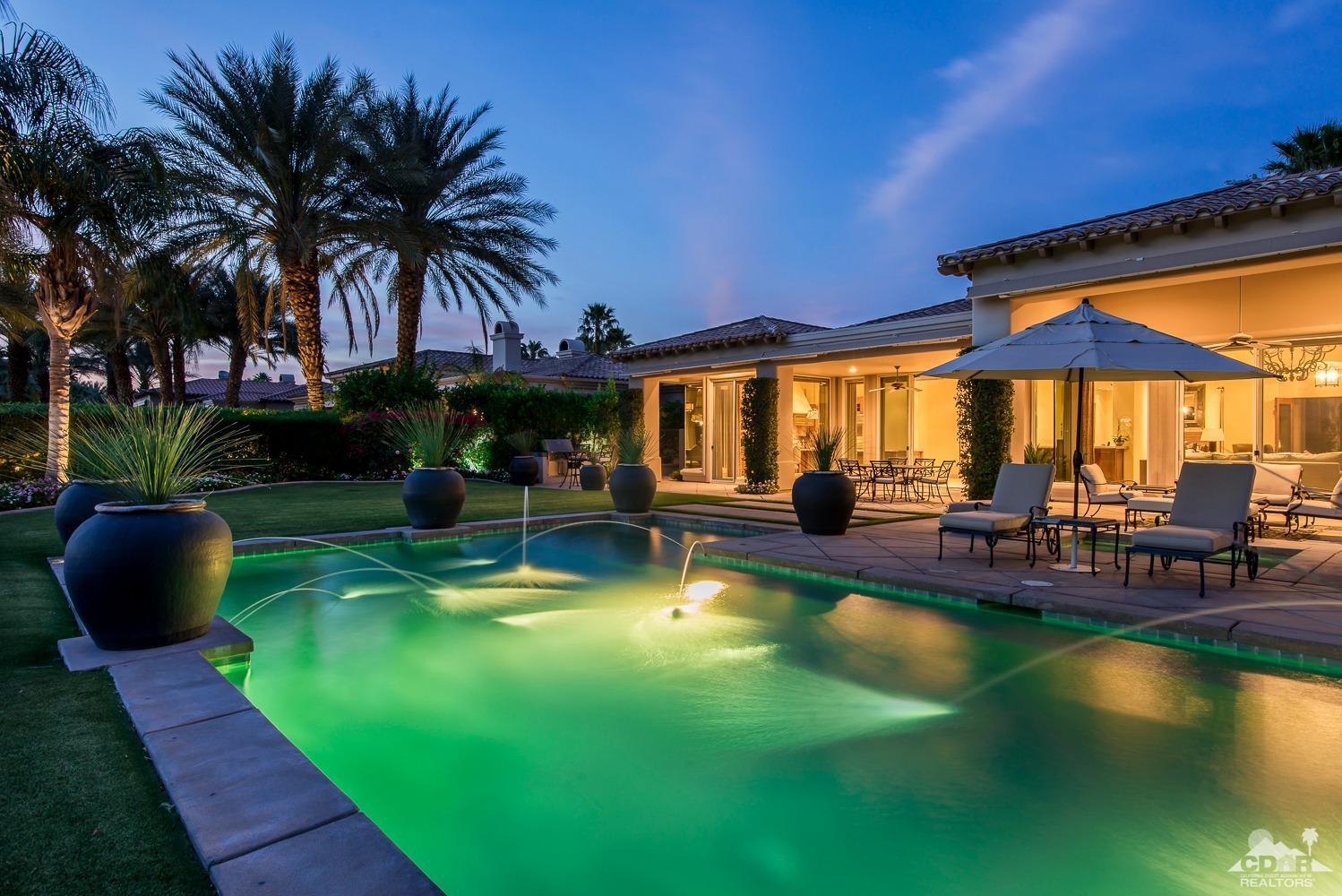 80515 Weiskopf La Quinta, CA 92253 - Photo 7 of 46 a view of a swimming pool with a table and chairs under an umbrella