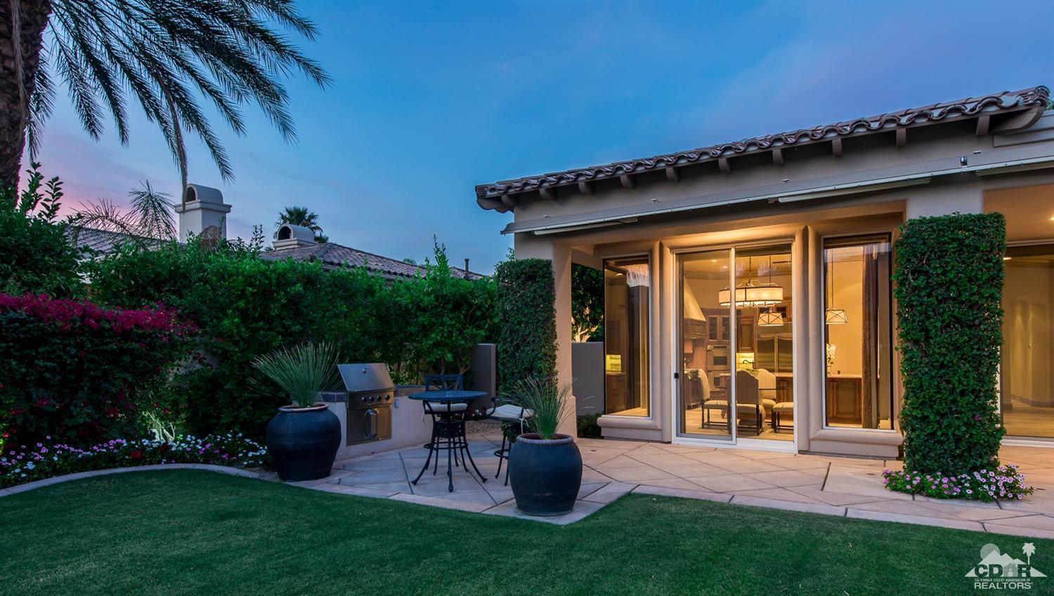 80515 Weiskopf La Quinta, CA 92253 - Photo 9 of 46 a view of a patio with table and chairs potted plants and floor to ceiling window and potted plants