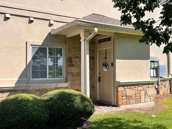 a view of front door and small yard