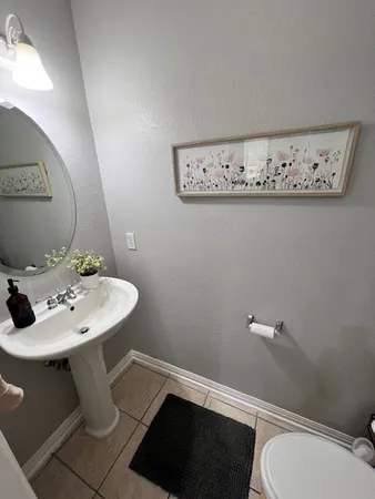 a bathroom with a sink mirror and toilet