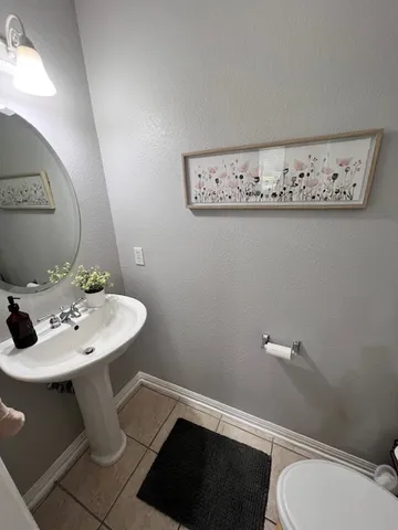 a bathroom with a sink mirror and toilet