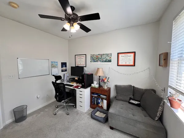 a view of a livingroom with workspace and a couch