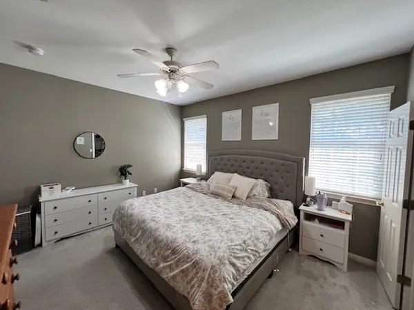 a bedroom with a bed and a chandelier