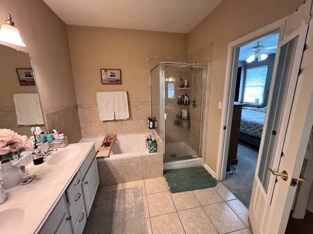 a bathroom with a double vanity sink a mirror and shower