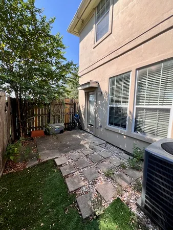 a view of a house with backyard and sitting area