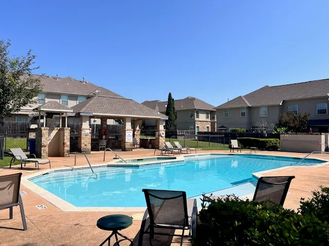 a view of a swimming pool with chairs and tables