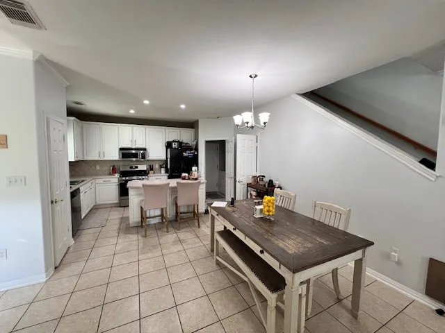a kitchen with stainless steel appliances a stove a sink and a refrigerator