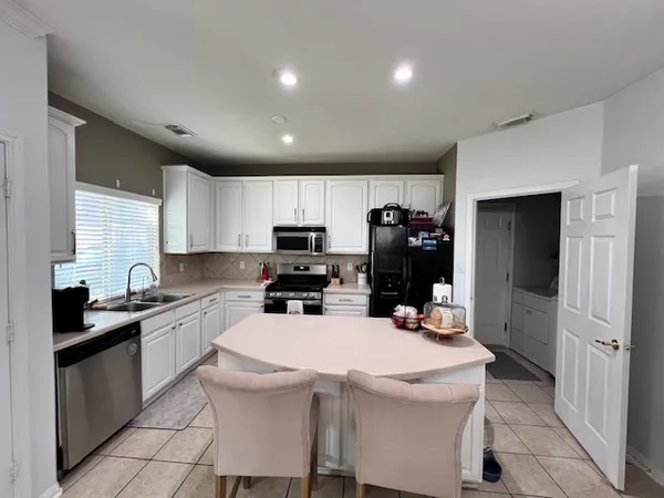 a kitchen that has a sink and cabinets
