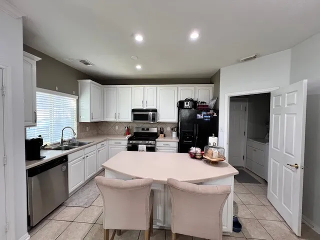 a kitchen that has a sink and cabinets