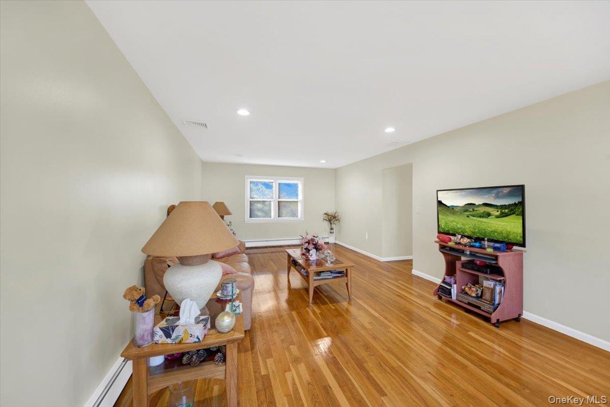 39 Deshon Avenue Bronxville, NY 10708 - Photo 11 of 30 a living room with furniture and a flat screen tv