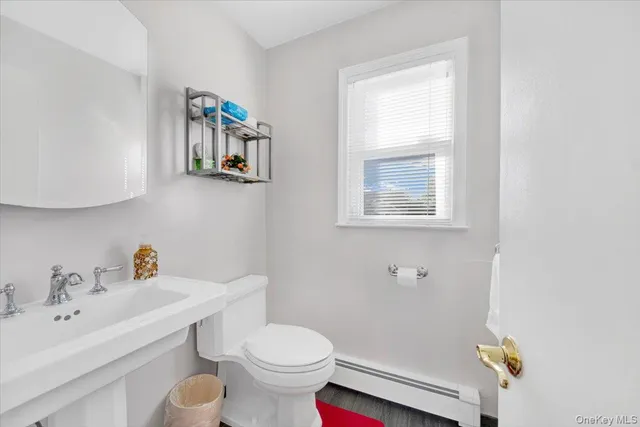 a bathroom with a sink mirror and toilet
