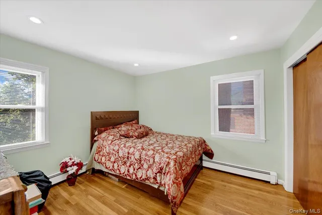 a bedroom with a bed and window