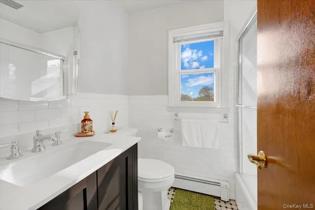 a bathroom with a sink toilet and vanity