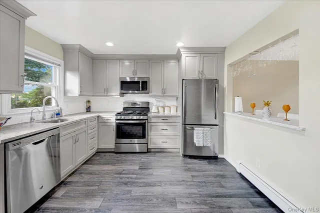 a kitchen with a refrigerator stove and sink