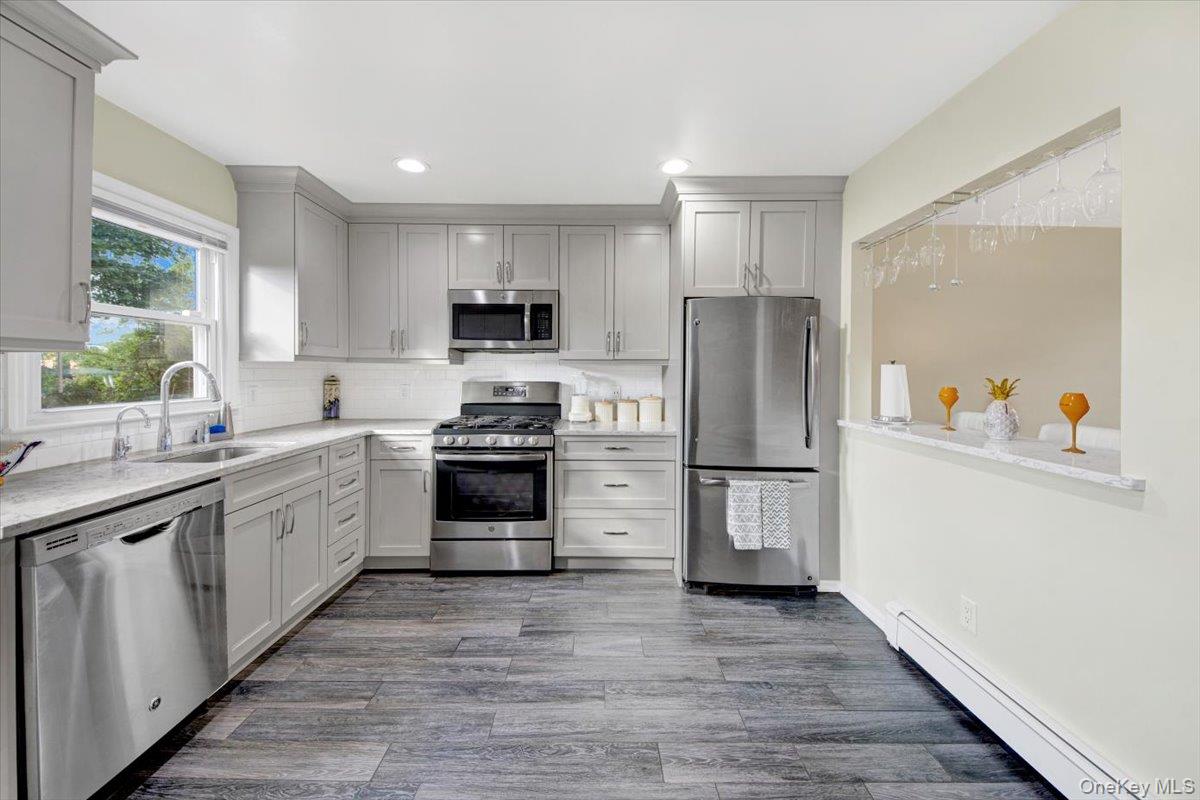 39 Deshon Avenue Bronxville, NY 10708 - Photo 2 of 30 a kitchen with a refrigerator stove and sink