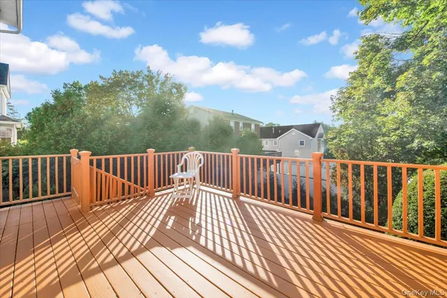 a view of balcony with wooden floor and fence