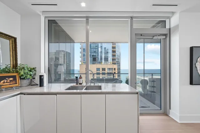 a bathroom with a granite countertop sink a mirror and a shower