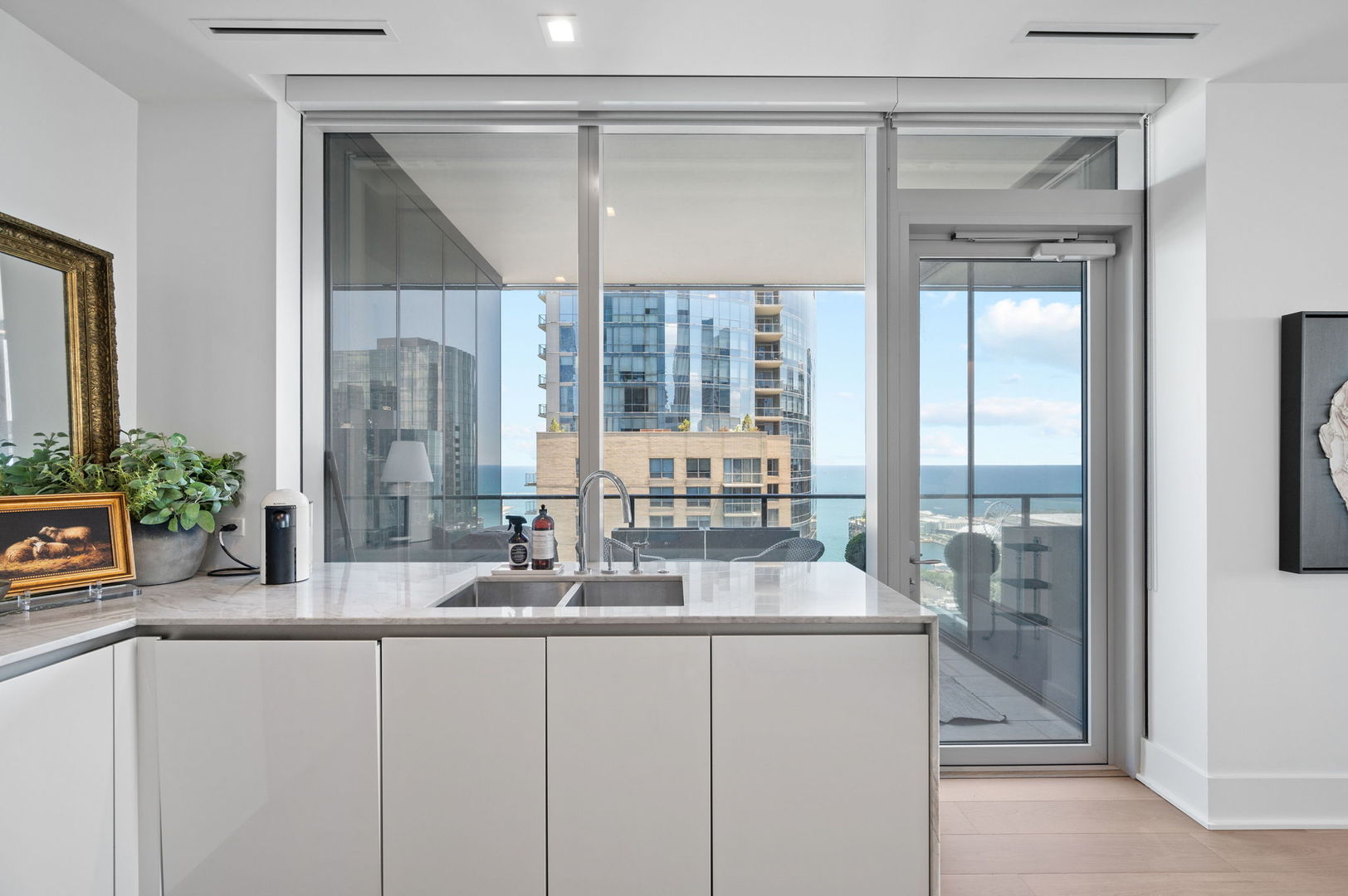 363 East Wacker Drive, Unit 3109 Chicago, IL 60601 - Photo 12 of 24 a bathroom with a granite countertop sink a mirror and a shower