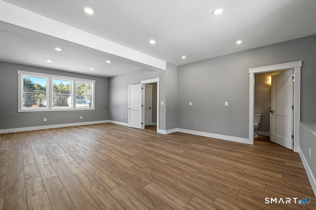121 New Road Thompson, CT 06277 - Photo 17 of 40 an empty room with wooden floor and a window